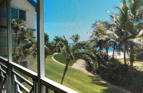 North Side Condo | Hello Sunshine! Beachfront 2BR 2BA condo Retreat Rum Point w/GYM, Tennis, &WiFi