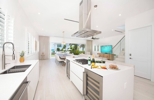 Northwest Point House | Oceans 9: Seaside Lazy River Pool, Sunken BBQ Ocean Lounge + Designer Interiors in West Bay